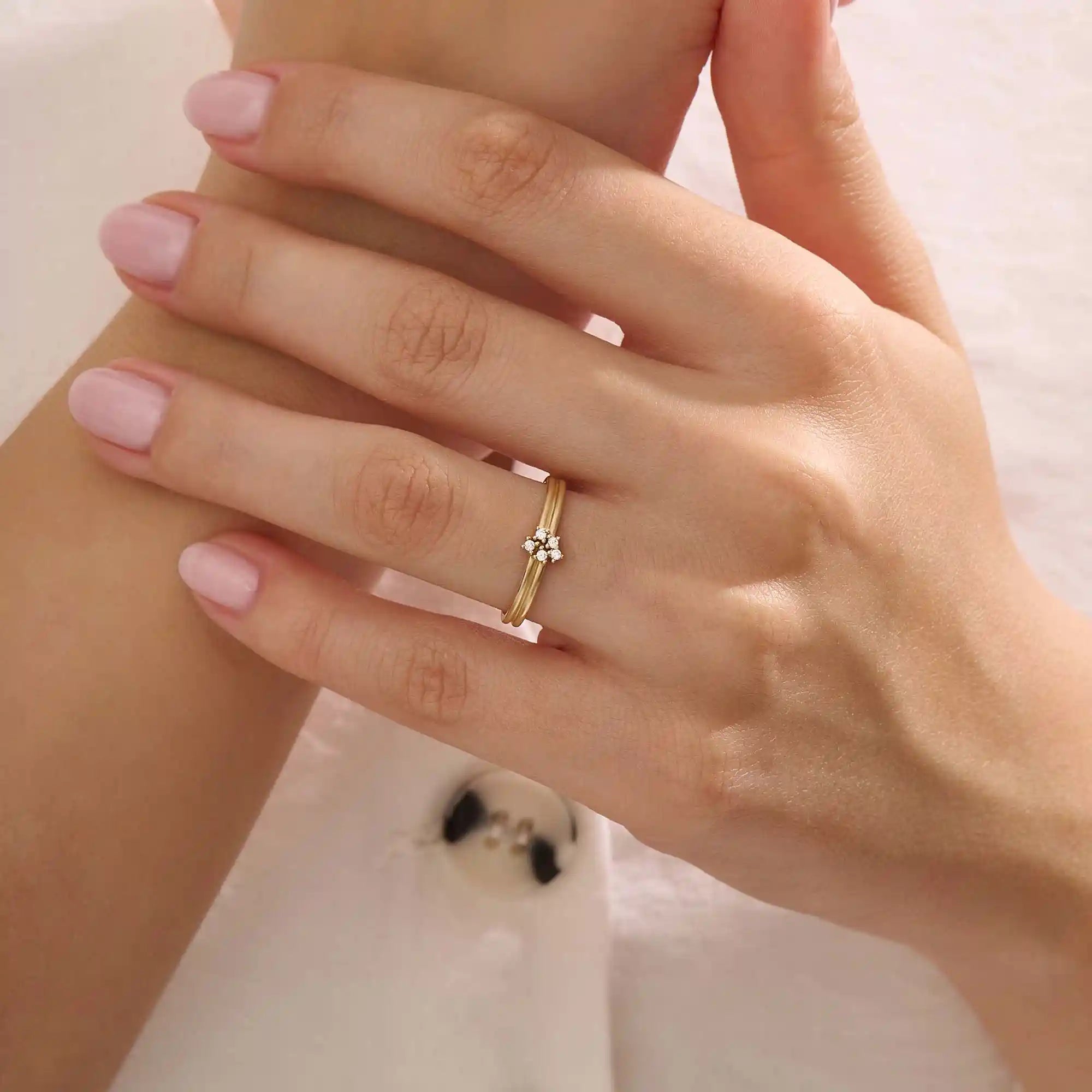 Model wears a 14k gold double band promise ring adorned with sparkling moissanites. A statement piece symbolizing commitment and style.