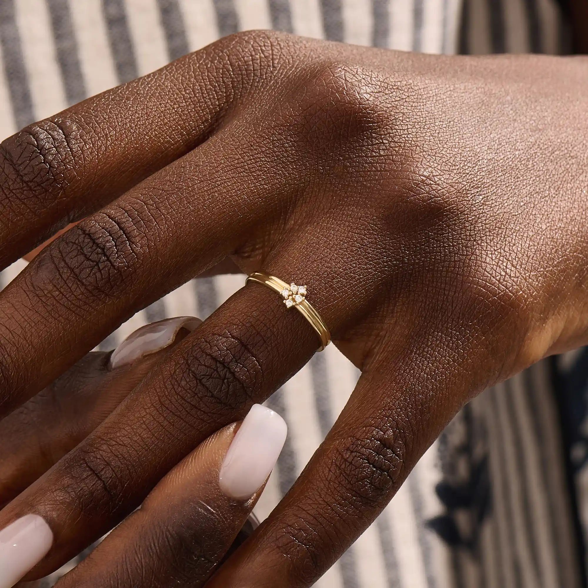 Model wears a 14k gold double band promise ring adorned with sparkling moissanites. A statement piece symbolizing commitment and style.