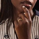 Model wears a 14k gold eternity statement ring featuring a beaded band and evil eye design. Stylish and meaningful everyday accessory.