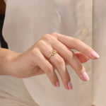 Model wears a 14k gold pinky signet ring adorned with moon and star engravings. A distinctive and stylish accessory for everyday wear.
