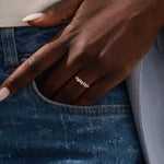 Model wears a 14k gold stacking ring featuring pavé marquise stones in an alternating ups and downs pattern. Perfect for layering with other rings.