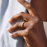 Model wears a 14k gold stacking ring featuring pavé marquise stones in an alternating ups and downs pattern. Perfect for layering with other rings.