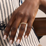Model wears a 14k gold statement ring with a leaf motif and moissanite accent. Elegant and versatile everyday accessory.