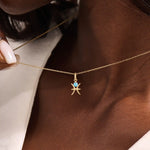 Model wears a 14k solid gold Pisces zodiac symbol pendant necklace with aquamarine, perfect for Pisces zodiac birthdays.