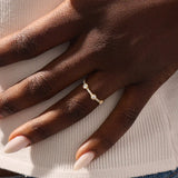 Model wears a 14k solid gold half-eternity stacking ring with three bezel moissanites. Elegant and perfect for layering.