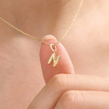 Model wears a 14k solid gold puffy letter necklace with a bold yet delicate look. The sculpted design adds a playful and personalized touch.