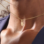 Model wears a 14k solid gold puffy letter necklace with a bold yet delicate look. The sculpted design adds a playful and personalized touch.
