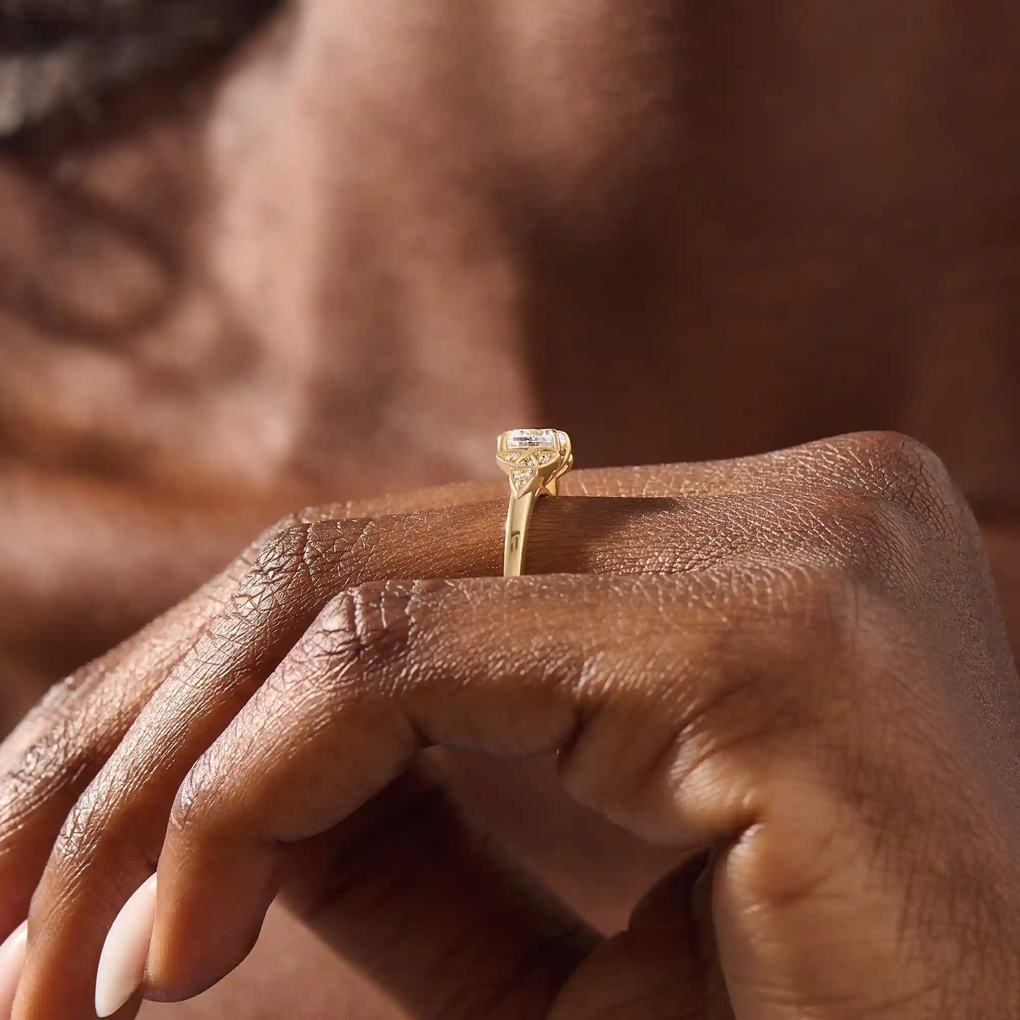 Model wears a 14k solid gold solitaire engagement ring with Celtic knot detailing and accent moissanites. Elegant and meaningful statement bridal jewelry.