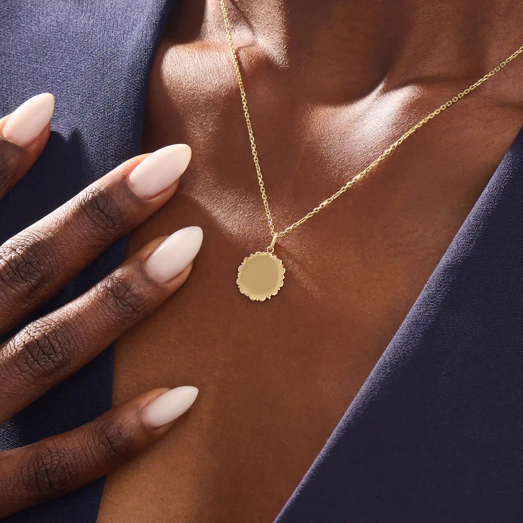 Model wears a 14k solid gold sun necklace with a clean, engravable center and subtle sunray edges. A simple and meaningful addition to any jewelry stack.