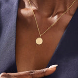 Model wears a 14k solid gold sun necklace with a clean, engravable center and subtle sunray edges. A simple and meaningful addition to any jewelry stack.