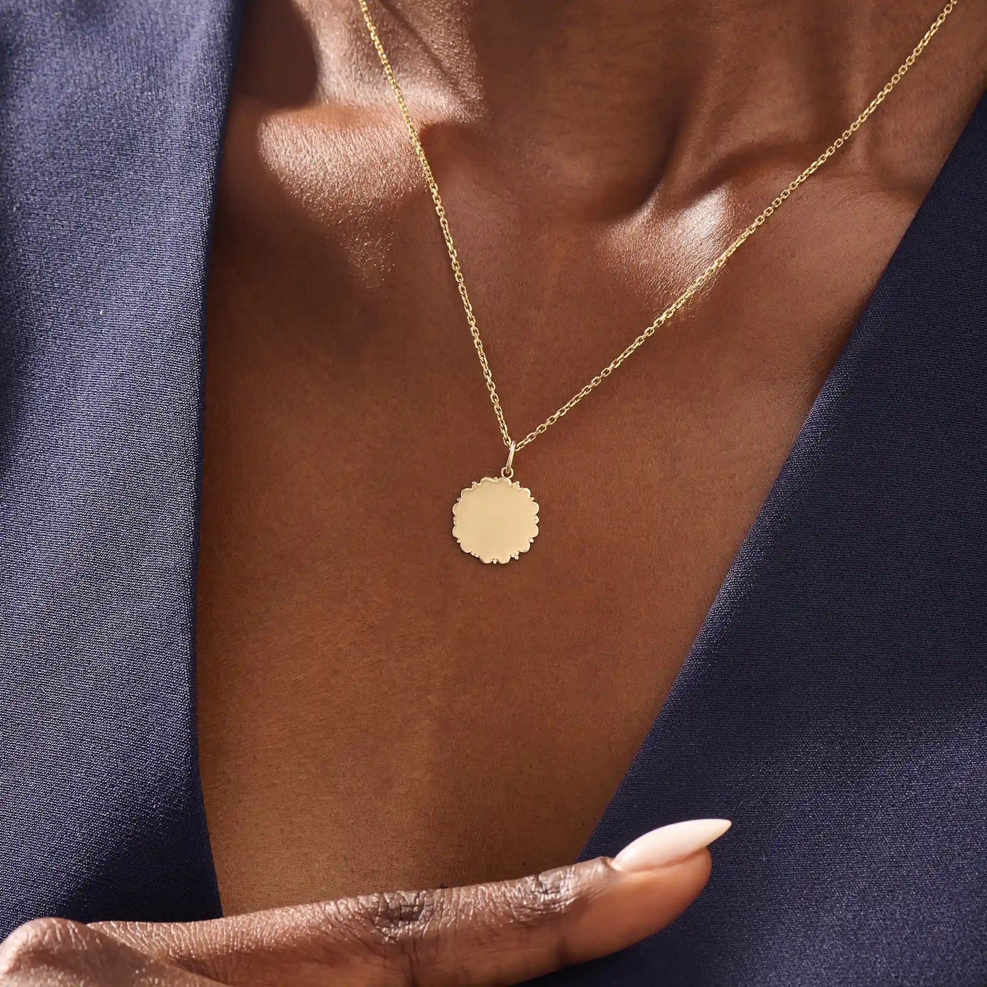 Model wears a 14k solid gold sun necklace with a clean, engravable center and subtle sunray edges. A simple and meaningful addition to any jewelry stack.