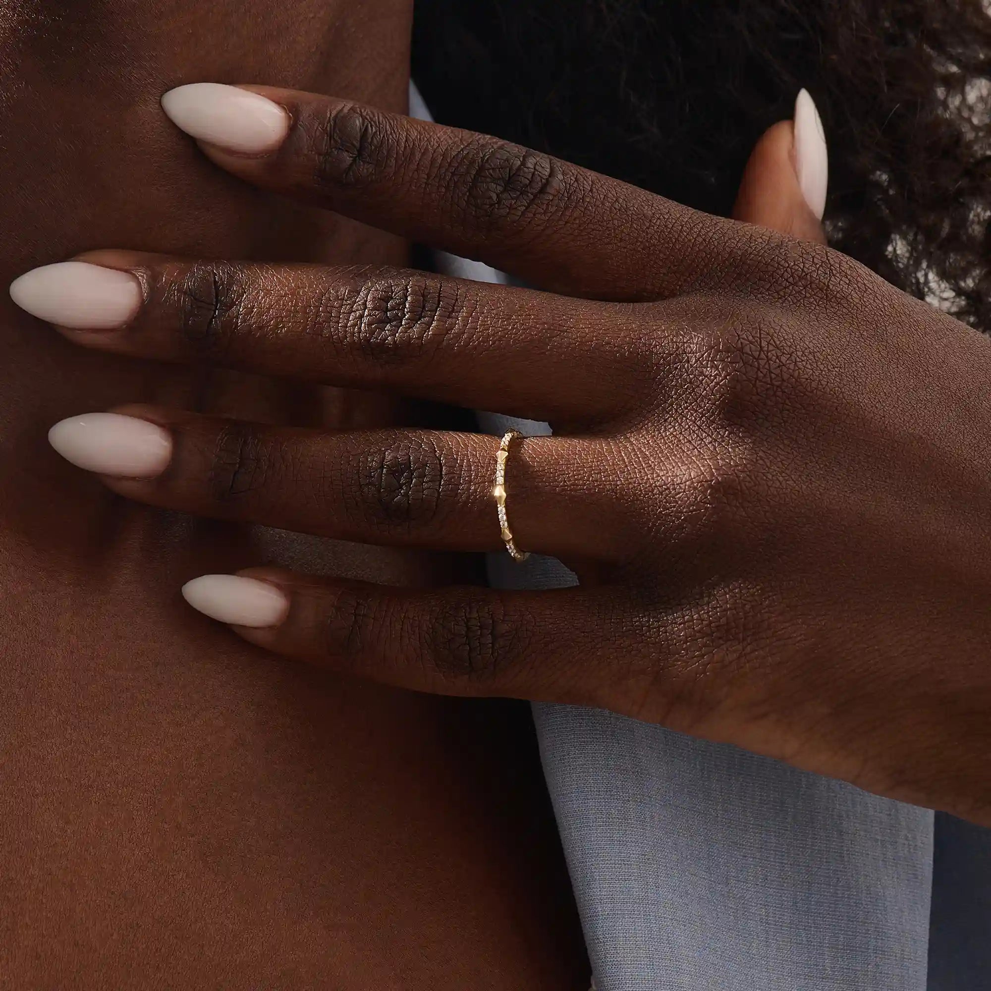 Model wears a 14k solid gold ultra-slim eternity spike stacking ring. Perfect for minimalist stacking and daily style.
