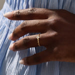Model wears a bezel set princess square cut solitaire engagement ring in 14k solid gold. Minimalist and timeless bridal style.