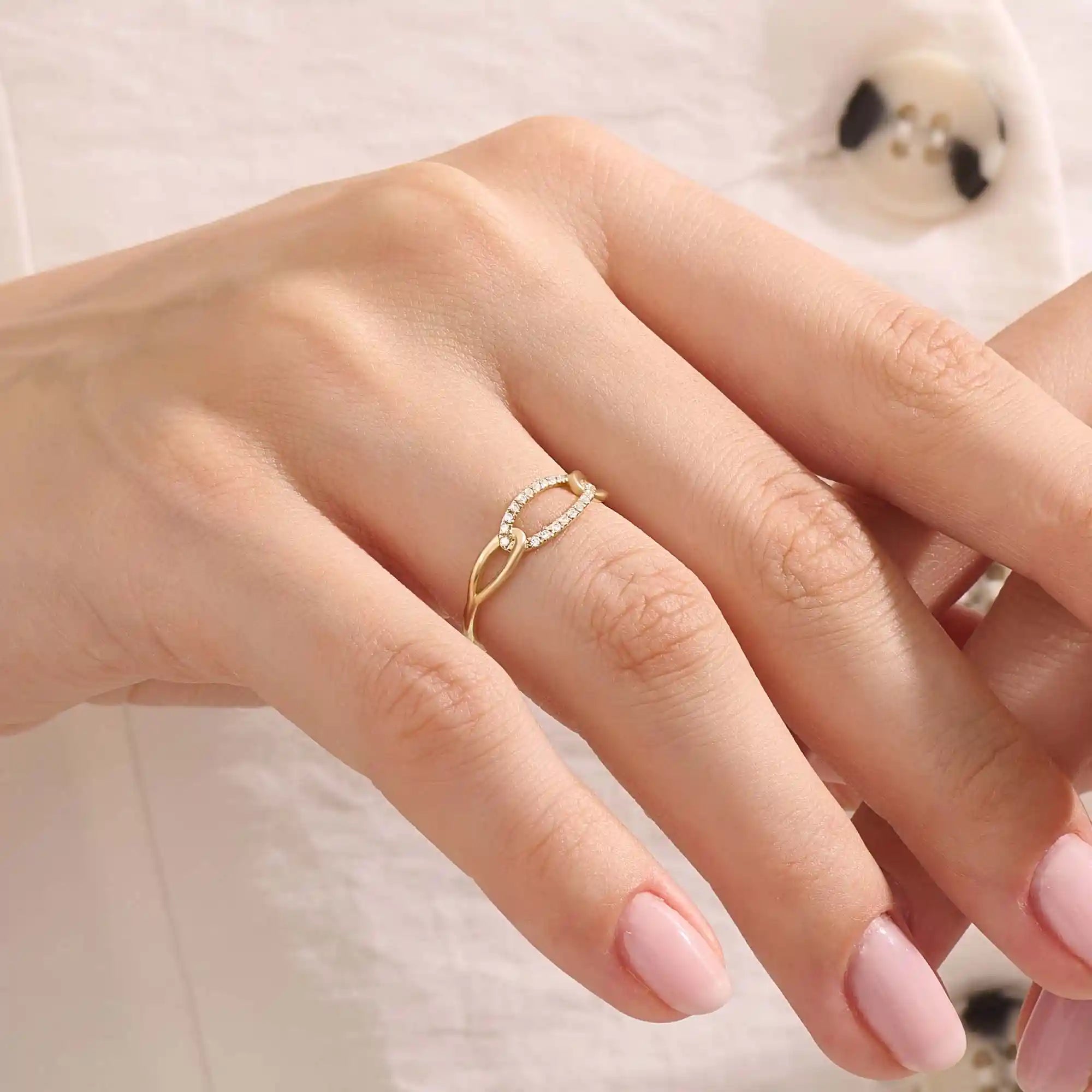 Model wears a bold pavé chain ring in 14k gold, featuring sparkling moissanites. A striking and glamorous addition to any jewelry stack.