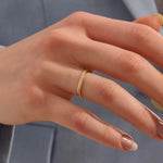 Model wears a dainty curved gold ring with beaded texture and a tiny moissanite. Minimalist and feminine, ideal for layering.