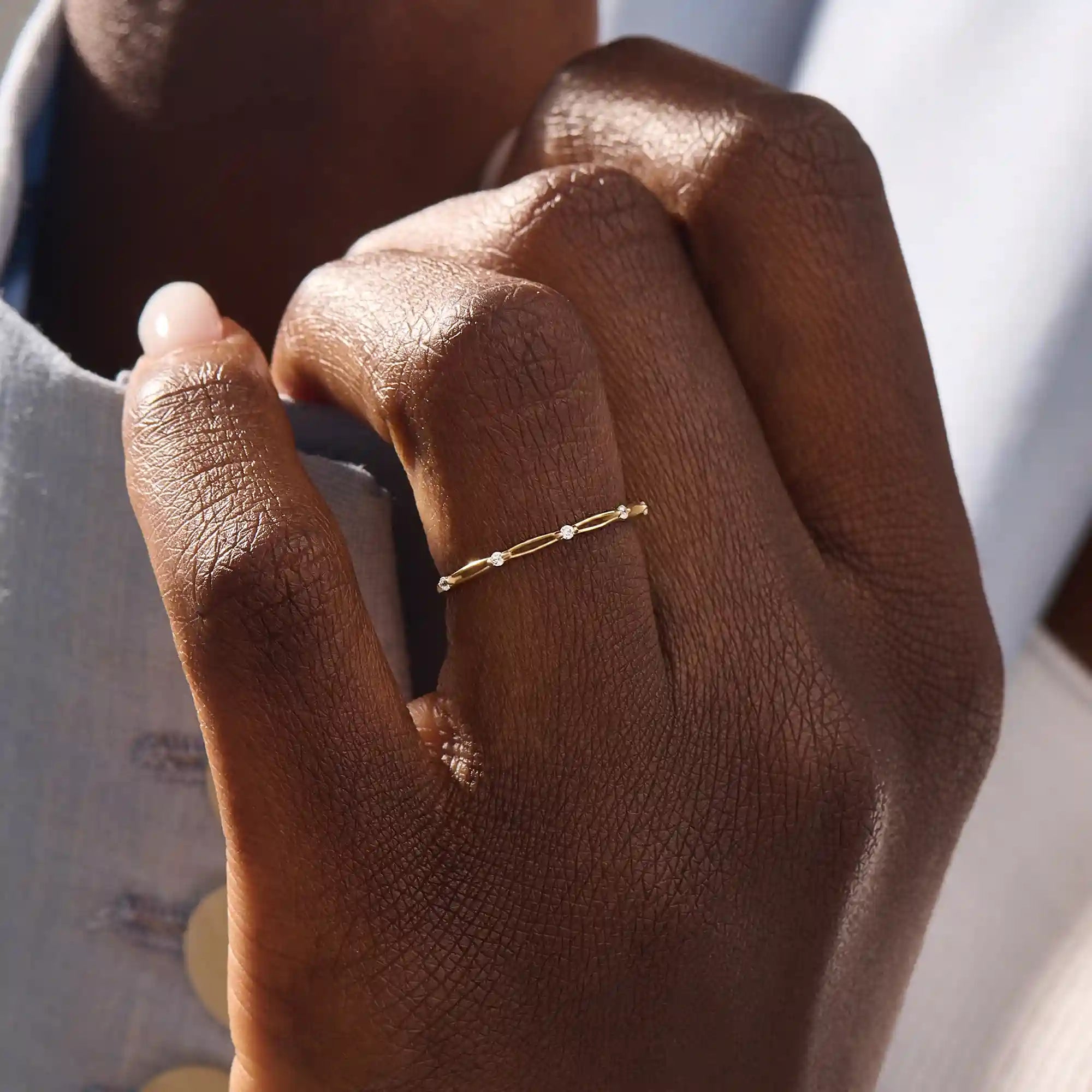 Model wears a slim 14k gold stacking ring with a clean minimalist style. Ideal for everyday wear and mixing with other rings.