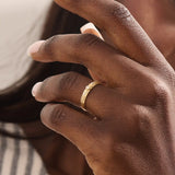 Model wears a vintage design 14k gold leaf band promise ring featuring detailed leaf engravings. Perfect for meaningful everyday wear or gifting.