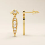 Nature-inspired dangling leaf stud earrings in 14k solid gold. Delicate and lightweight design perfect for everyday elegance.