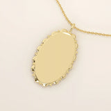 Oval-shaped 14k solid gold necklace with a smooth, plain surface, perfect for engraving. A minimalist and timeless jewelry piece.