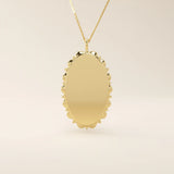 Oval-shaped 14k solid gold necklace with a smooth, plain surface, perfect for engraving. A minimalist and timeless jewelry piece.