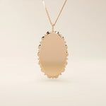Oval-shaped 14k solid gold necklace with a smooth, plain surface, perfect for engraving. A minimalist and timeless jewelry piece.