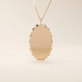 Oval-shaped 14k solid gold necklace with a smooth, plain surface, perfect for engraving. A minimalist and timeless jewelry piece.