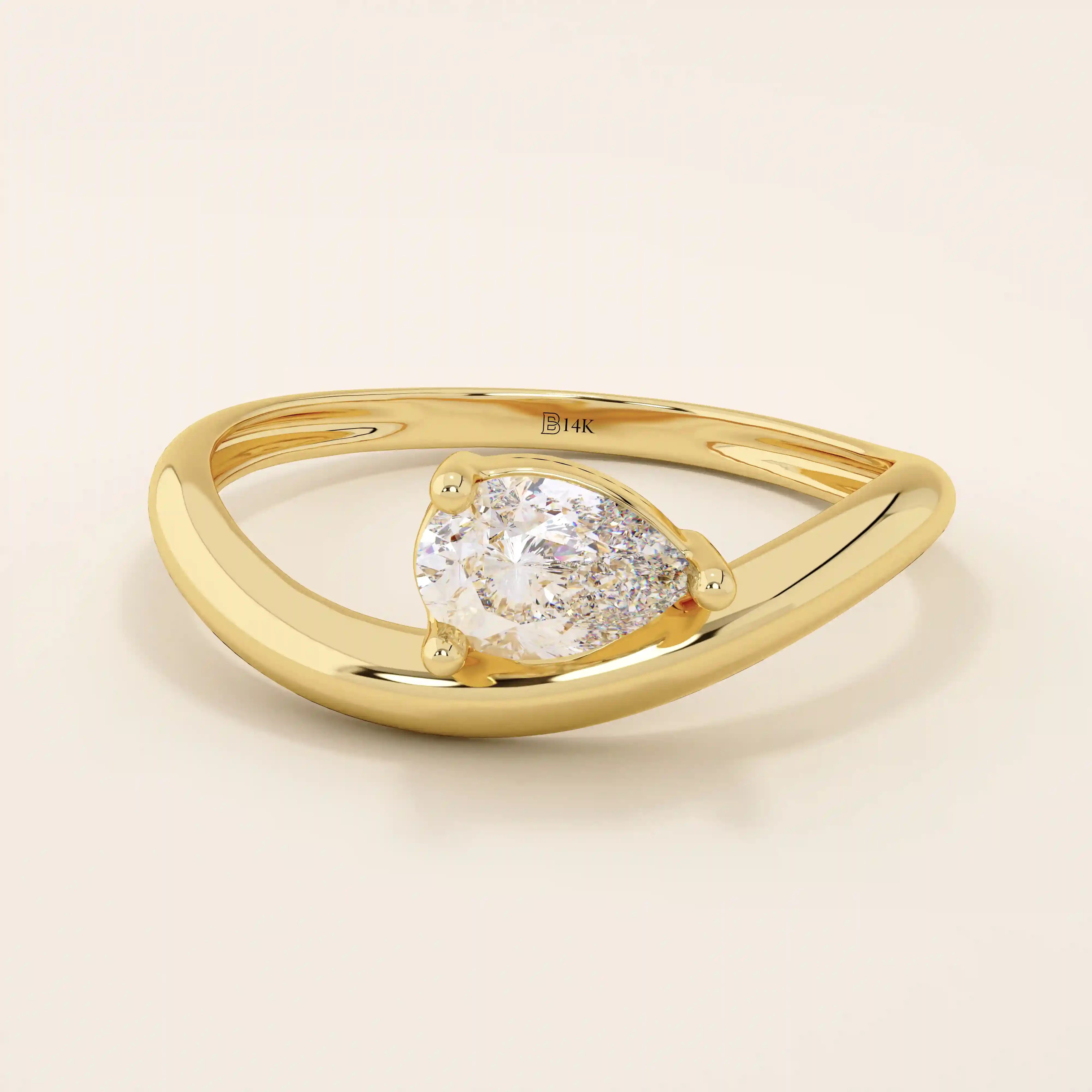 Pear cut moissanite solitaire engagement ring on a curved 14k solid gold band, minimalist design with a modern twist.