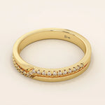 Side angle view of a 14k solid yellow gold band with pointed chevron design and pavé set round brilliant cut moissanite stones, contemporary and refined bridal jewelry
