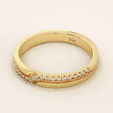 Side angle view of a 14k solid yellow gold band with pointed chevron design and pavé set round brilliant cut moissanite stones, contemporary and refined bridal jewelry
