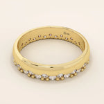 Side angle view of a 14k solid yellow gold band with round brilliant cut moissanite stones in a single row and bead accents, sophisticated and minimal bridal jewelry
