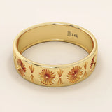 Side angle view of a 14k solid yellow gold engraved wedding band with repeating floral and fan motifs
