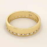 Side angle view of a 14k solid yellow gold wedding band with baguette-cut moissanite stones in a continuous channel setting
