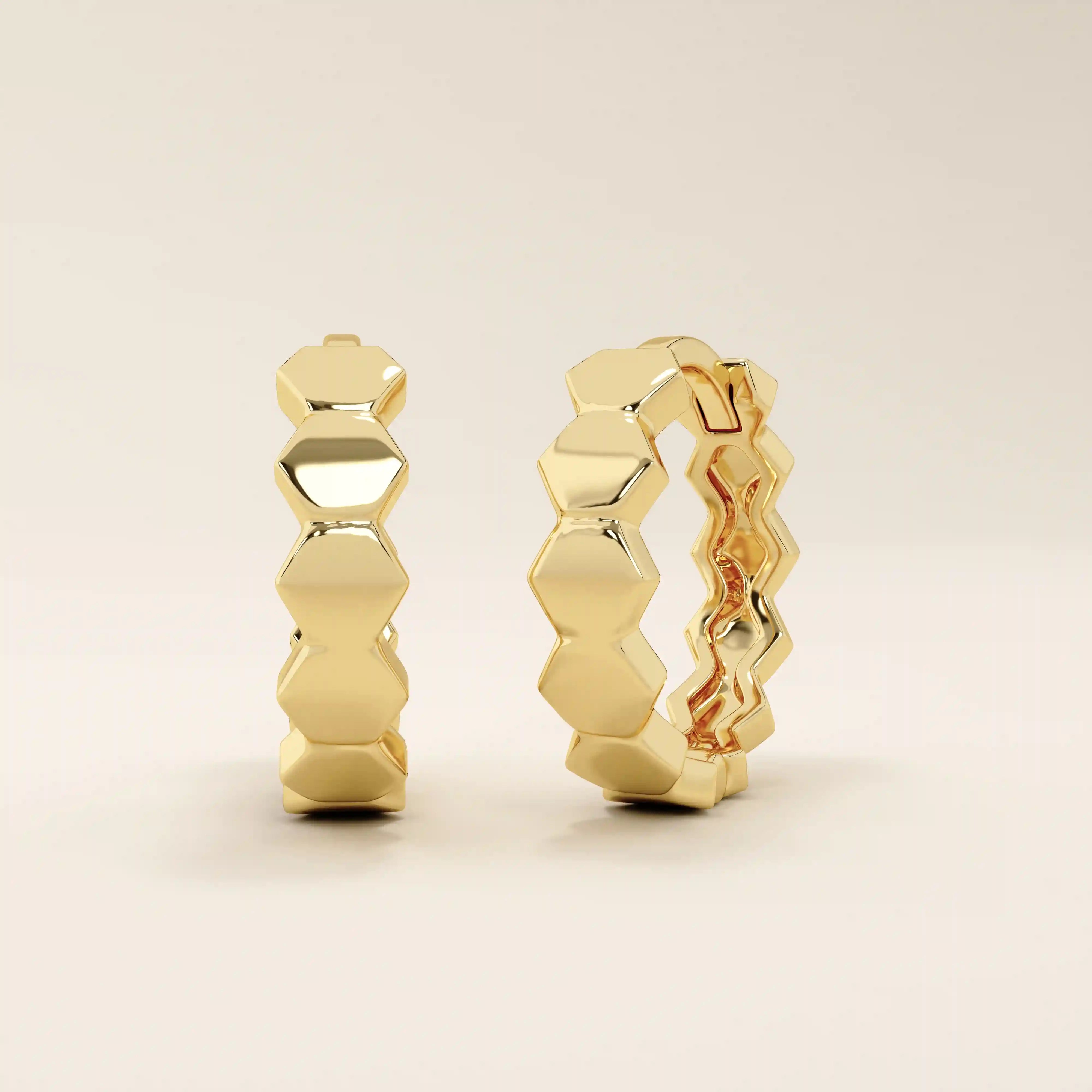 Side profile of 14k solid yellow gold hexagon hoop earrings, showcasing the seamless connection of each angular link in a bold geometric silhouette.
