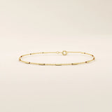 Side view of a 14k solid yellow gold bar chain bracelet, showing the slender rectangular links and highly polished finish that catches the light beautifully.
