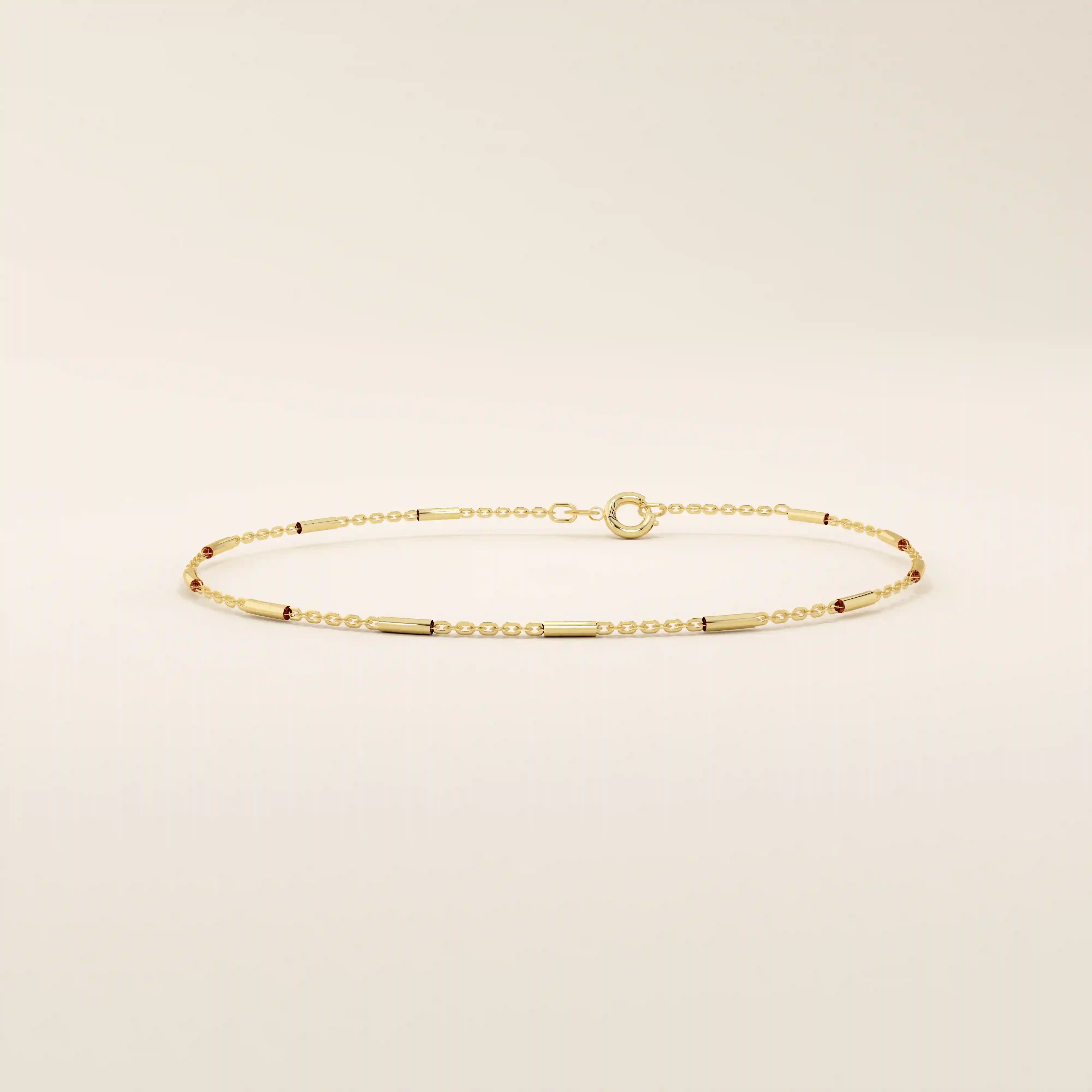 Side view of a 14k solid yellow gold bar chain bracelet, showing the slender rectangular links and highly polished finish that catches the light beautifully.
