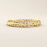 Side view of a 14k solid yellow gold twisted rope bangle showcasing its dimensional braided design, smooth contours, and lustrous finish.

