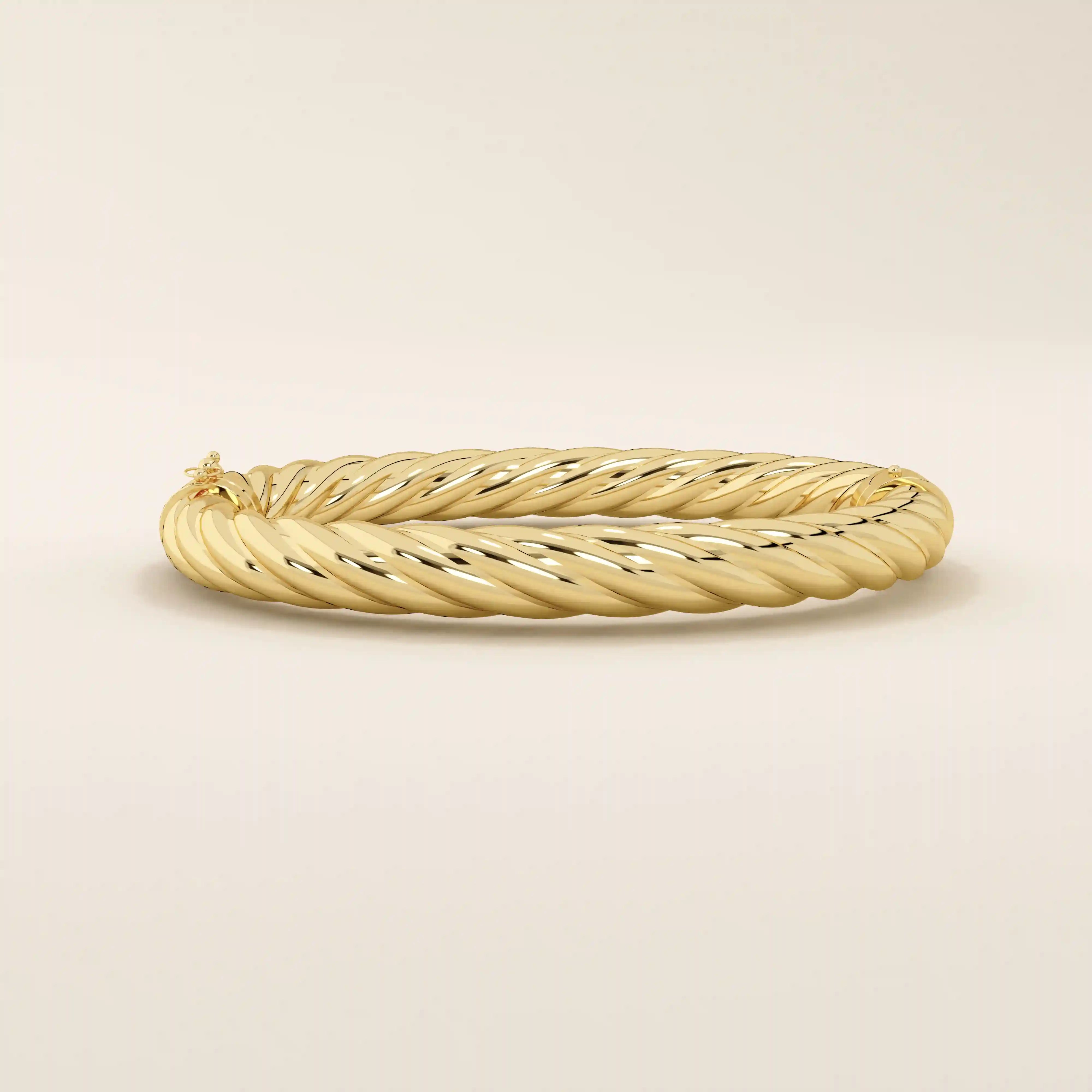 Side view of a 14k solid yellow gold twisted rope bangle showcasing its dimensional braided design, smooth contours, and lustrous finish.
