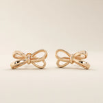 Simple ribbon stud earrings in 14k rose gold with an elegant bow-inspired design.
