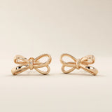 Simple ribbon stud earrings in 14k rose gold with an elegant bow-inspired design.
