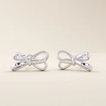 Simple ribbon stud earrings in 14k white gold, crafted in a delicate bow shape.
