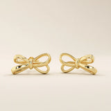 Simple ribbon stud earrings in 14k yellow gold with a polished bow design.
