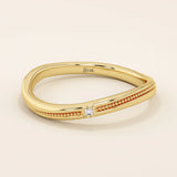 Slim curved ring in 14k solid gold with a beaded band and a single tiny moissanite. A delicate and stackable everyday piece.