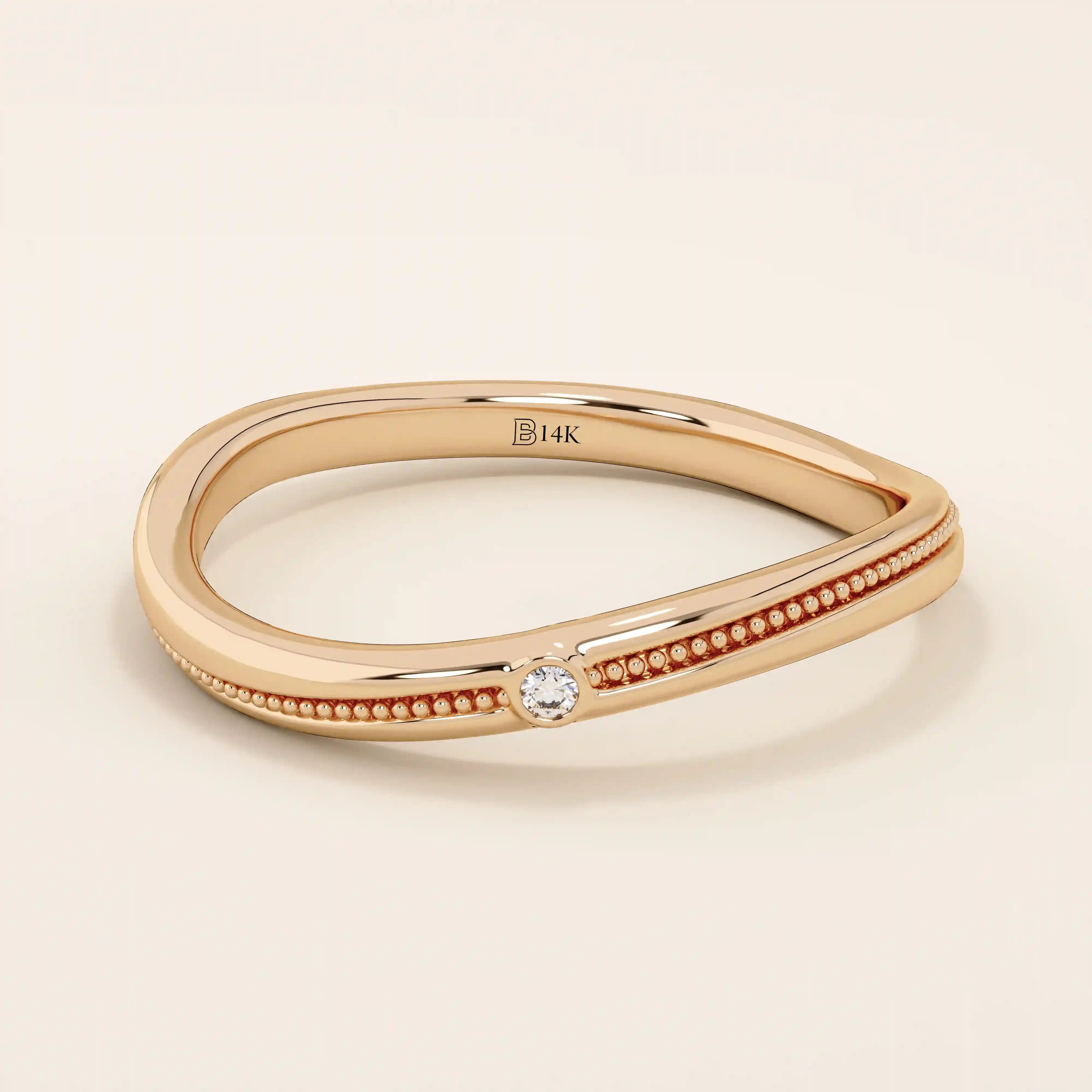 Slim curved ring in 14k solid gold with a beaded band and a single tiny moissanite. A delicate and stackable everyday piece.