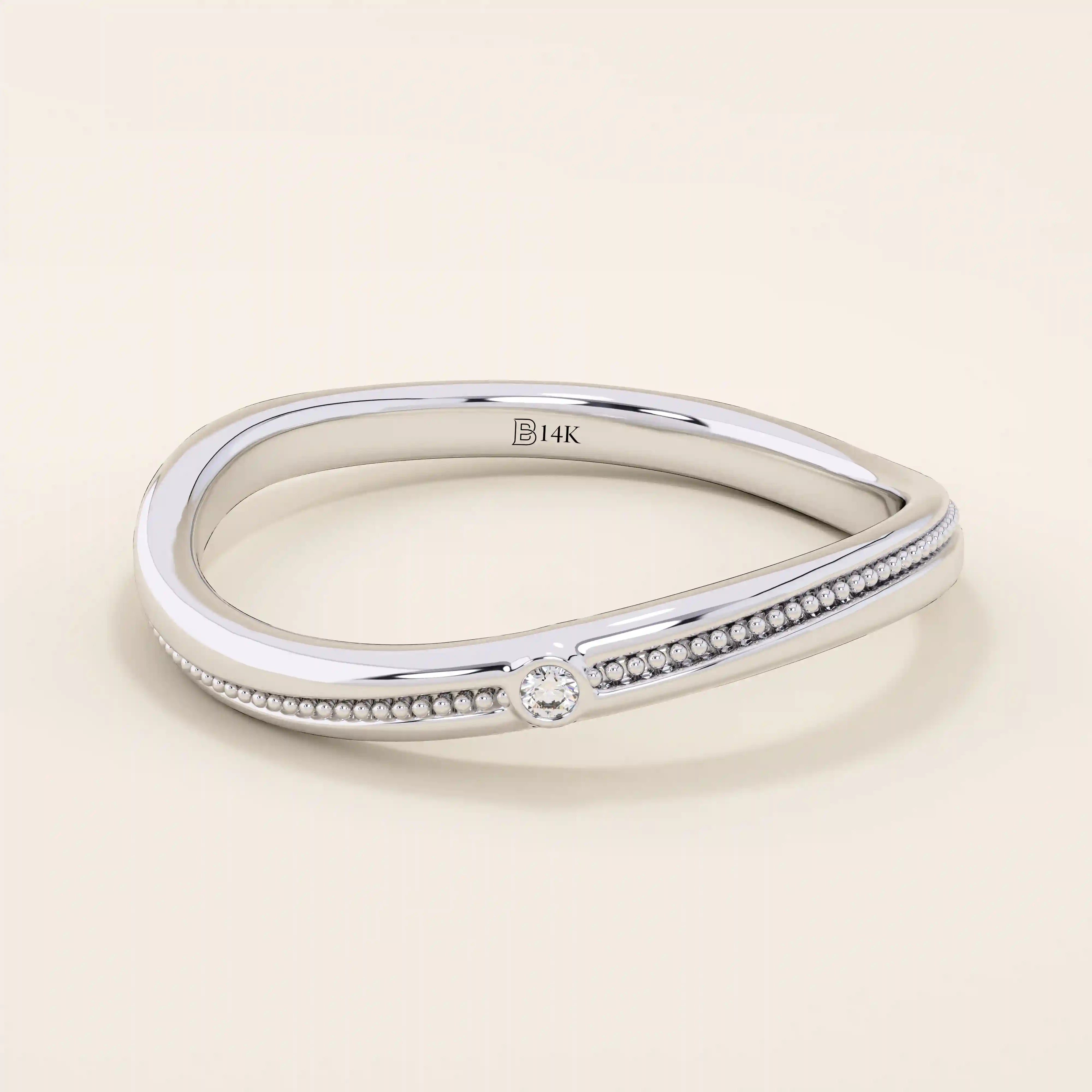 Slim curved ring in 14k solid gold with a beaded band and a single tiny moissanite. A delicate and stackable everyday piece.