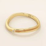 Slim curved ring in 14k solid gold with a beaded band and a single tiny moissanite. A delicate and stackable everyday piece.