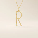 Slim initial letter necklace in 14k solid gold, accented with tiny moissanites for subtle sparkle. A sleek and personal everyday accessory.
