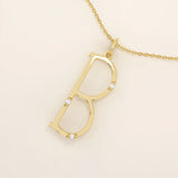 Slim initial letter necklace in 14k solid gold, accented with tiny moissanites for subtle sparkle. A sleek and personal everyday accessory.