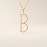 Slim initial letter necklace in 14k solid gold, accented with tiny moissanites for subtle sparkle. A sleek and personal everyday accessory.