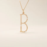 Slim initial letter necklace in 14k solid gold, accented with tiny moissanites for subtle sparkle. A sleek and personal everyday accessory.