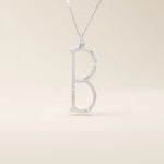 Slim initial letter necklace in 14k solid gold, accented with tiny moissanites for subtle sparkle. A sleek and personal everyday accessory.